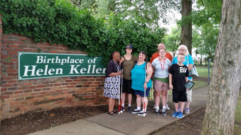 picture of Deaf Blind Community on the right and on the left a sign that says birthplace of Hellen Keller