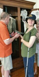 Photo: Renee and I holding one of Helen’s or her mother’s shoes. “Wow! What a small shoe!”